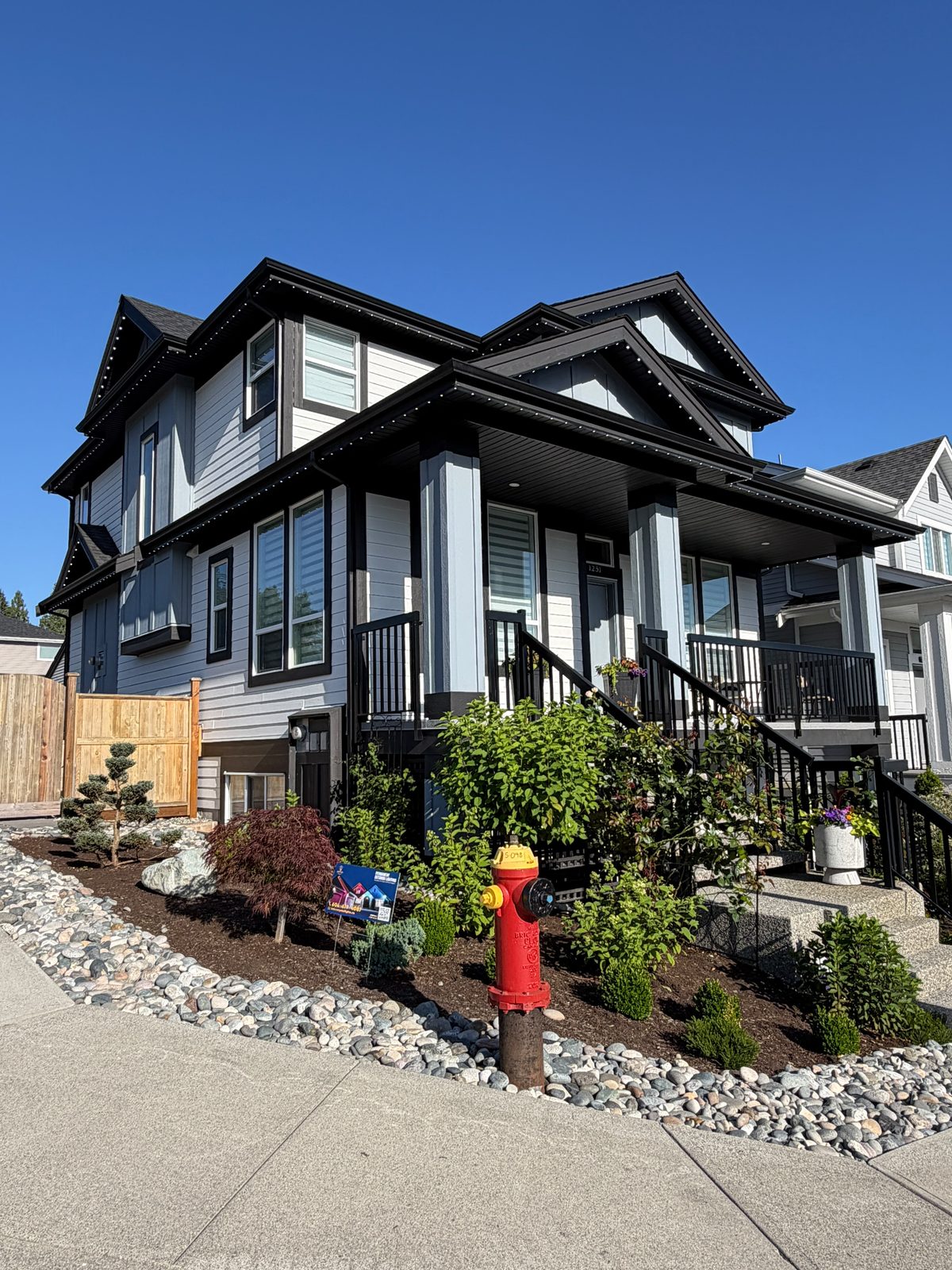 A home in daylight where the installed lighting track reads as a clean trim line along the roof.