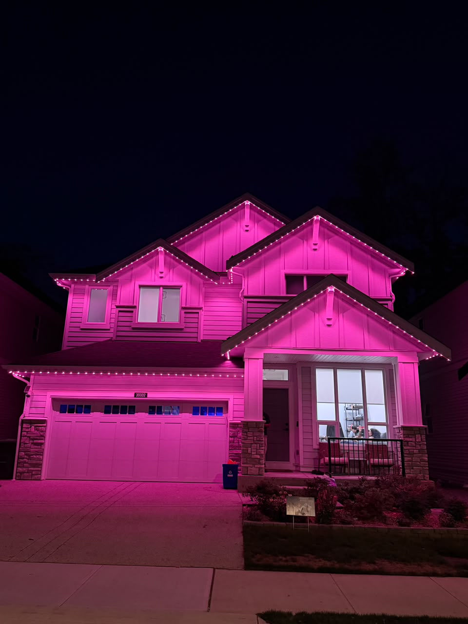 Vivid glowing magenta celebration lighting on home.