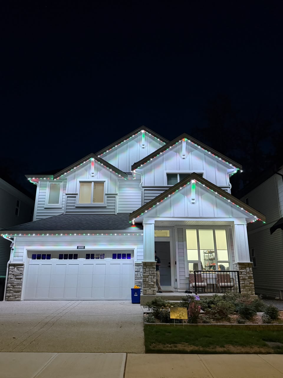 Home illuminated in festive holiday Christmas red and green.