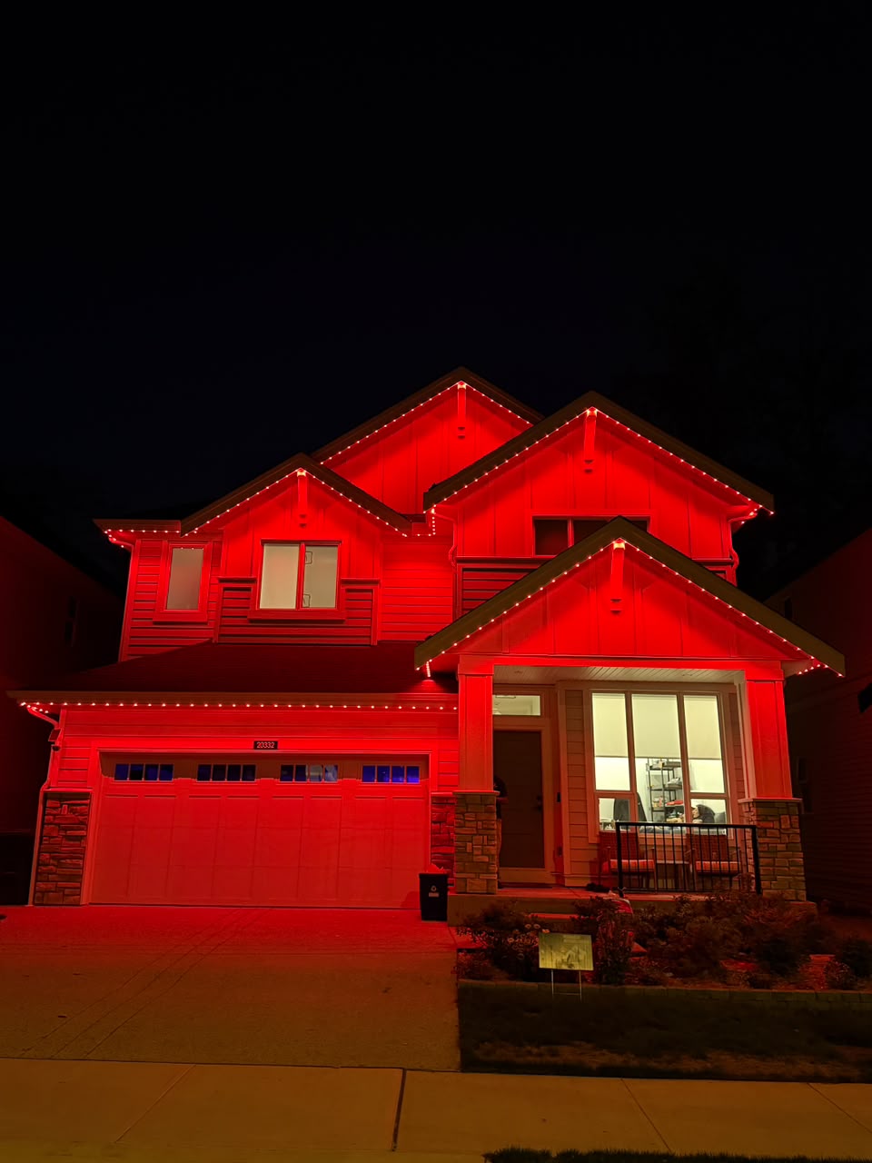 Bold crimson red illumination along rooflines and peaks.