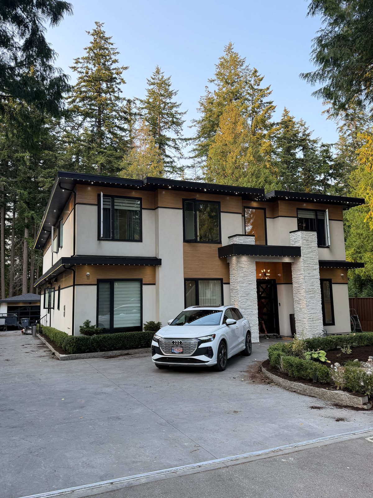 A modern home with sharp roofline illumination in White Rock.